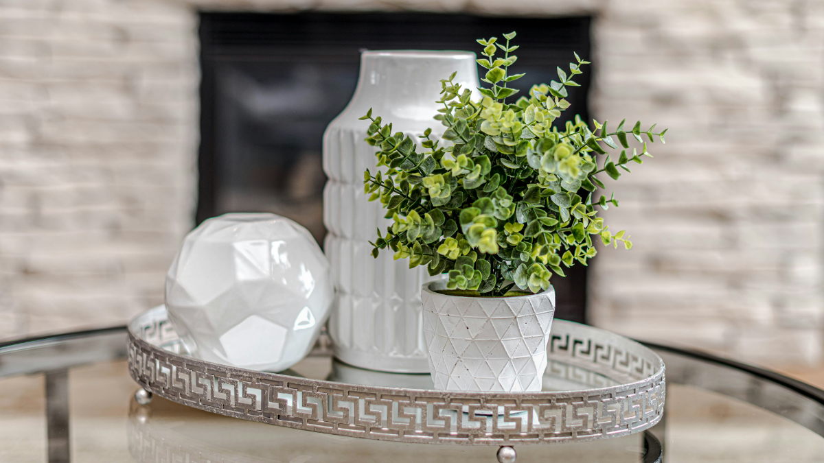 Three white showpieces of different heights and textures grouped together to demonstrate the rule of three in interior styling.